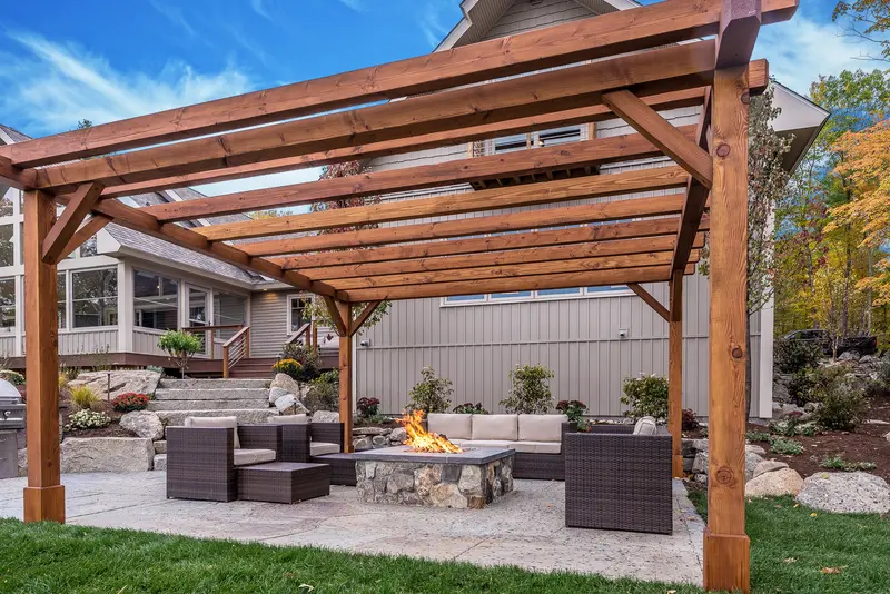 Outdoor patio under a rustic wooden pergola structure. Outdoor patio under a rustic wooden pergola structure.