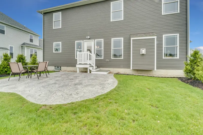 Custom stamped concrete patio in a spacious backyard. Custom stamped concrete patio in a spacious backyard.
