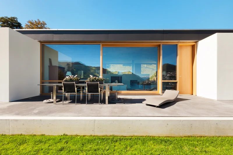 Modern minimalist home featuring smooth concrete backyard terrace Modern minimalist home featuring smooth concrete backyard terrace