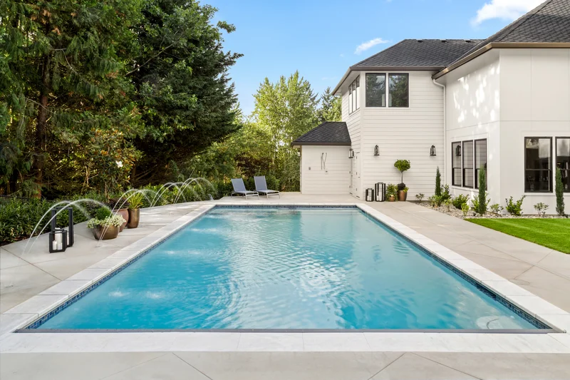 Luxurious custom concrete pool deck surrounding an inground swimming pool. Luxurious custom concrete pool deck surrounding an inground swimming pool.