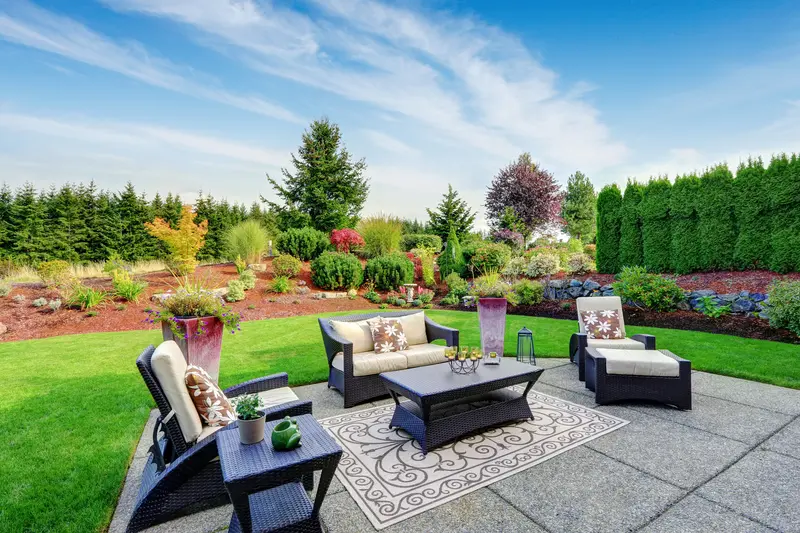 Stamped concrete patio with stylish outdoor furniture and garden. Stamped concrete patio with stylish outdoor furniture and garden.