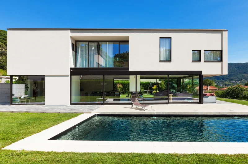 Modern home featuring a clean concrete pool surround and patio. Modern home featuring a clean concrete pool surround and patio.