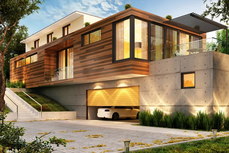 Modern luxury home with concrete driveway and architecture.